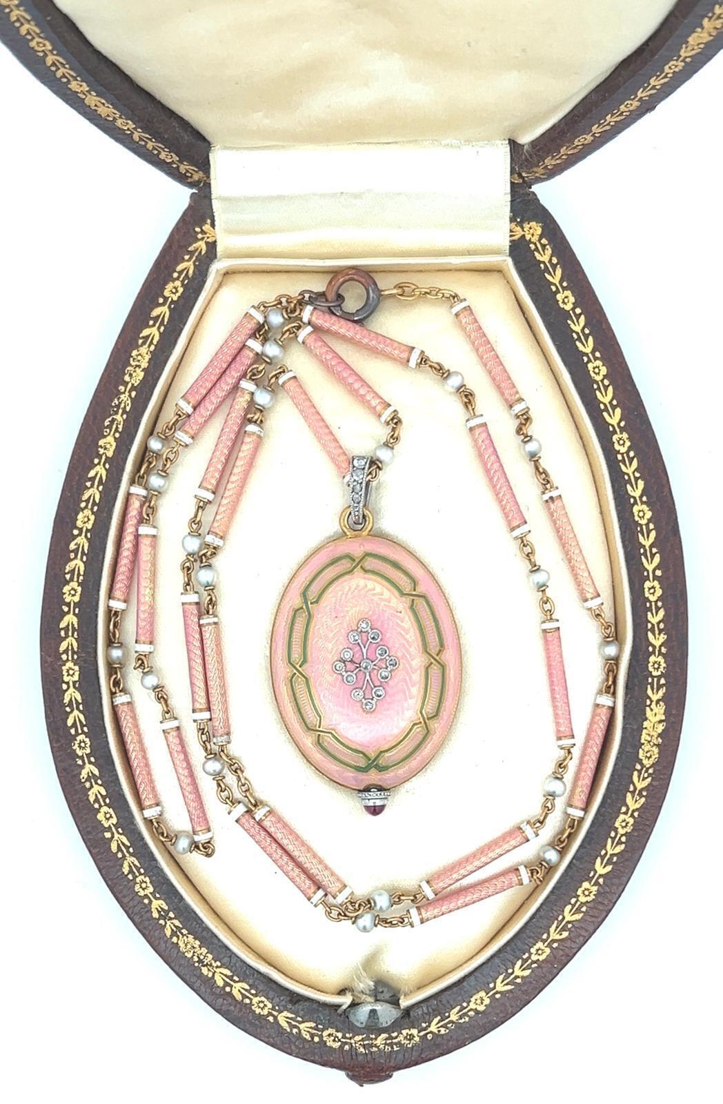 BELLE EPOQUE FRENCH 18K GOLD, ENAMEL, PLATINUM AND DIAMOND OVAL PENDANT WATCH WITH CHAIN, CIRCA 1915